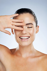 Image showing Skincare, beauty and happy face of a woman in studio with a smile for natural cosmetic product. Aesthetic model person with hand for makeup, facial and dermatology for skin glow and spa wellness