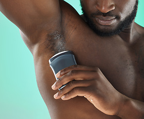 Image showing Armpit hygiene and black man with deodorant and self care routine product of people with body zoom in studio. Health, wellness and cosmetic grooming of young person at isolated green background