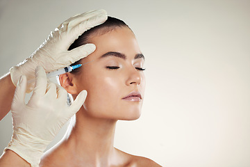 Image showing Dermatology, woman or injection for plastic surgery, beauty or filler with gloves on studio background. Lady, female or collagen for skincare, needle for procedure or cosmetics for healthy skin