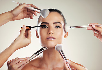 Image showing Makeup, beauty and brush on face of a woman in studio for powder cosmetic product. Aesthetic model person with professional hands for facial skincare and dermatology for skin glow and salon results