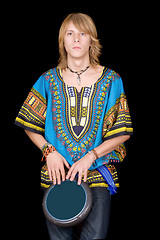 Image showing The young man plays a drum. Isolated