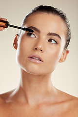 Image showing Face, mascara makeup and beauty of woman in studio for luxury eyelash cosmetics product. Headshot of aesthetic model with brush for volume lashes or facial skin glow, shine and self care results