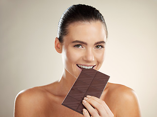 Image showing Beauty portrait, eating and woman with chocolate, junk food or dessert for sugar sweets, candy snack or cheat meal. Cosmetics makeup, skincare and hungry model with cacao product for antioxidants