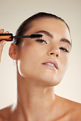 Image showing Beauty, mascara makeup and face for woman portrait in studio for luxury eyelash cosmetic product. Headshot of aesthetic model person with brush for volume with facial skin glow, shine and results