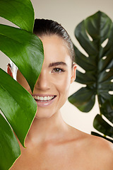 Image showing Woman, beauty and skincare portrait with plant for natural skin dermatology or cosmetic product. Happy face aesthetic model in studio for sustainable self care with green leaf for health and wellness