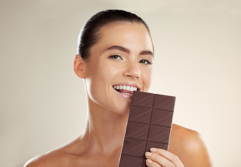 Image showing Beauty portrait, eating and woman with chocolate bar, junk food or dessert for sugar sweets, candy snack or cheat meal. Cosmetics makeup, skincare and hungry model with cacao product for antioxidants