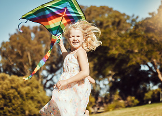 Image showing Kite, running and girl run in an outdoor park with summer fun and smile. Nature, children vacation and happiness of kids in sunshine with freedom and smiling with energy on green grass feeling young