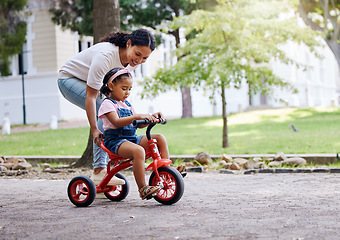 Image showing Mother teaching child, bike and learning in park, outdoor with growth and development, family and care. Nature, learn to ride tricycle with woman and girl, childhood and parenting with happy female