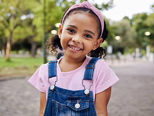 Image showing Portrait, young girl and smile in park, happy child outdoor with nature and freedom with positive mindset. Travel, happiness and adventure, growth and childhood with family day out and youth mockup