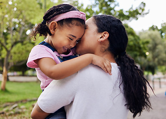 Image showing Mother, daughter and kiss in a park, love and sweet while bonding outdoor together. Black woman, girl and kissing face in a forest for fun, precious and happy, laugh and relax in moment of motherhood