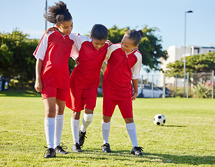 Image showing Soccer, injury and children team help, support and walk with hurt friend during game at a sports field. Sport, accident and kids football group helping girl player after fitness, training and match