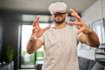 Image showing Virtual reality glasses, technology and hands of man in home with headset for interactive, online and 3d games. Futuristic, user interface and male with vr for metaverse, cyberspace and gaming ux