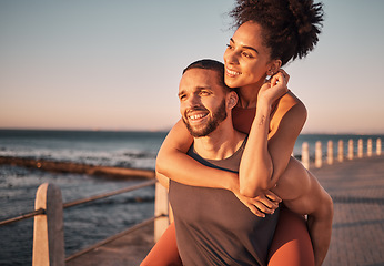 Image showing Beach, sunset and couple piggyback in summer enjoying holiday, vacation and quality time on weekend. Love, dating and black man and woman relax after running, fitness workout and training by ocean