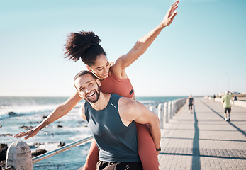 Image showing Beach, fitness and couple piggyback in summer enjoying holiday, vacation and quality time on weekend. Love, dating and black man and woman relax after running, exercise workout and training by ocean