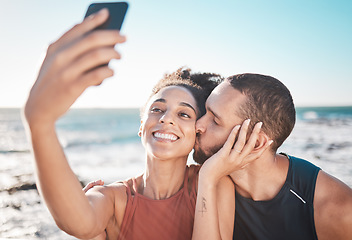 Image showing Selfie kiss, love and couple with a phone for streaming, training and care at the beach in Bali. Gratitude, exercise and affectionate man and woman with a smile for a mobile photo after a workout