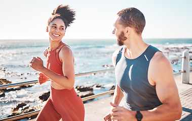 Image showing Running, fitness and exercise with a sports couple outdoor in summer for cardio or endurance by the ocean. Health, training and sea with a man and woman runner on a promenade for a workout together