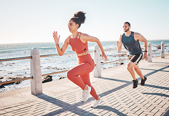 Image showing Running, fitness and ocean with a sports couple outdoor during summer for cardio or endurance exercise. Health, training and sea with a man and woman runner on a promenade for a workout together