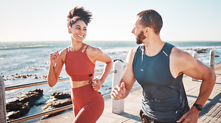 Image showing Running, fitness and water with a sports couple outdoor during summer for cardio or endurance exercise. Health, training and ocean with a man and woman runner on a promenade for a workout together