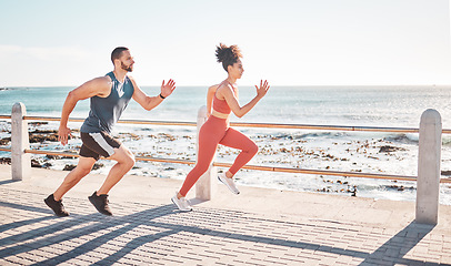 Image showing Runner, fitness and sea with a sports couple outdoor during summer for cardio or endurance exercise. Health, training and ocean with a man and woman running on a promenade for a workout together