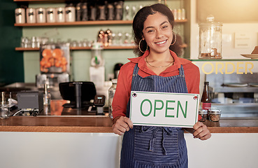 Image showing Small business, portrait or black woman with an open sign to welcome sales in cafe or coffee shop. Marketing, female manager or happy entrepreneur smiles while advertising or opening a retail store