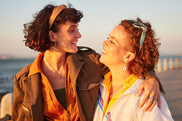 Image showing Lesbian, lgbtq and couple of friends at the beach with love, hug and excited for summer holiday and date. Sunset, sea and smile of women or gay people with pride, freedom and gen z solidarity in sun
