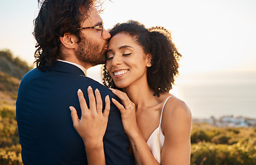 Image showing Love, kiss and wedding with couple in nature for celebration, happiness and romance. Sunset, hug and affectionate with bride and groom in embrace at countryside for happy, marriage and smile together