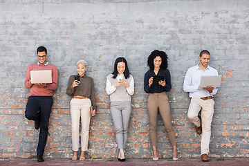 Image showing Recruitment, technology and people in waiting room for job search, internship opportunity or career diversity. Brick wall, creative mock up and group on hr website, laptop and phone for we are hiring