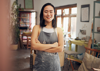 Image showing Woman, potter or arms crossed portrait in pottery studio, small business or Asian ceramic workshop. Smile, happy or clay product worker and confidence, vision ideas or goals for creative store design