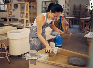 Image showing Pottery, startup business and woman cleaning in workshop for art class, production and manufacturing. Asian artist at creative potter workplace for clay or ceramic school, trade or process with pride