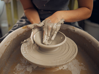 Image showing Clay, pottery or hands in designer workshop working on an artistic cup or mug mold in small business studio. Hand of creative artist or worker manufacturing handicraft products in sculpture process