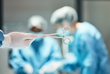 Image showing Hospital scissors, surgery and team of doctors in theatre for medical trust, innovation or support with healthcare insurance background. Hand holding tools, surgeon or nurse helping in operating room