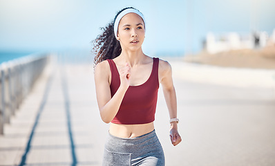 Image showing Woman running at beach promenade for fitness, energy and strong summer body. Female runner, sports person and athlete at seaside for marathon, cardio exercise and healthy wellness workout in sunshine