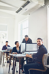 Image showing Mature, portrait and business man by computer in office workplace. Leadership, manager or confident male employee working on marketing report, advertising or sales project with colleagues in company.