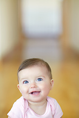 Image showing Baby, mockup and growth with an adorable girl child looking curious in her home alone for development. Face, smile or mock up and a cute female infant with blue eyes in a house feeling happy