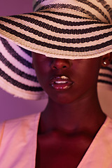 Image showing Fashion, model and black woman in neon light, UV and purple studio background wearing a sun hat. Style, makeup and beauty by female with dark skin aesthetic creativity and color design