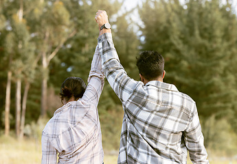 Image showing Success, hiking and back of couple holding hands in forest for achievement, victory or fitness goals. Travel, freedom and man with woman celebrating milestone, journey and adventure goal in nature