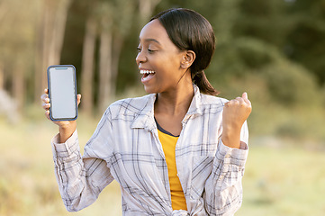 Image showing Black woman, phone and mockup display for winning, discount or sale with smile in nature. Happy African American female smiling for giveaway prize, deal or achievement on smartphone in the outdoors