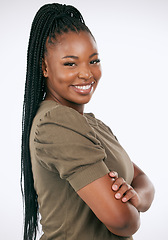 Image showing Happy, smile and portrait of a black woman in studio with a casual, stylish and fashion outfit. Happiness, excited and female model with braids standing with crossed arms isolated by white background