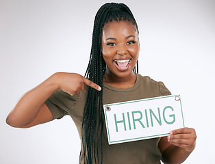 Image showing Creative business woman, pointing and hiring sign for recruiting isolated on gray studio background. Portrait of happy African American female manager with board for recruitment, job hire or startup