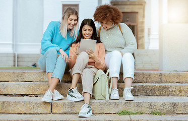 Image showing Student, friends and tablet on stairs in social media, communication or streaming entertainment at campus. Happy women enjoying online research, chat or browsing on touchscreen together on staircase