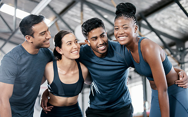 Image showing Diversity, fitness and team with smile for exercise, workout or training together at the indoor gym. Happy diverse group of people in sports teamwork, huddle or hug smiling for healthy exercising