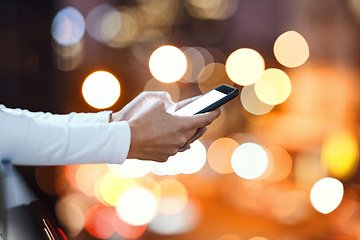 Image showing Closeup, hands and person texting in a city at night, blank and screen with mockup against bokeh background. Zoom, fingers and hand with smartphone and copy space for text, chat or online search