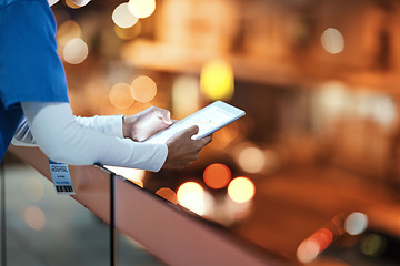 Image showing Tablet, hands and nurse at hospital rooftop working on telehealth, research or online consultation in city. Bokeh, healthcare and woman with touchscreen technology for wellness app in clinic at night