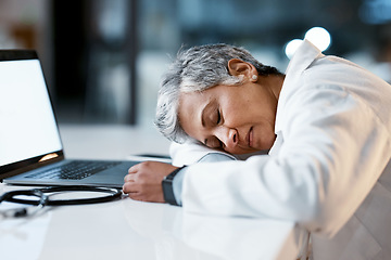 Image showing Healthcare, overtime and doctor sleeping at laptop, burnout and exhausted from research with mockup. Stress, sleep and woman in medicine at desk, tired and napping at work late at night in hospital.