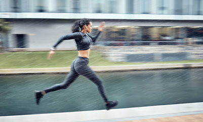 Image showing Sprinting, fast and woman running in the city for fitness, training and morning energy in Germany. Exercise, sports and athlete runner with focus during outdoor cardio for body performance in motion