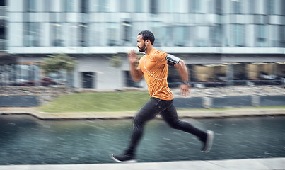 Image showing Blurred, fitness and man running as exercise in the city training, workout and workout outdoors in a town. Athlete, runner and fit male sprint fast for wellness, cardio and health lifestyle