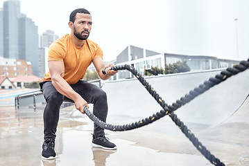 Image showing Outdoor, exercise and man with ropes, workout or training for wellness, fitness or healthy lifestyle. Outside, male or athlete swinging battle ropes, body care or intense movement for energy or power