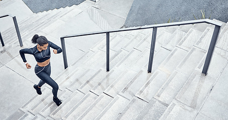 Image showing Fitness, above and woman running on stairs for training, sports and body energy in the city. Challenge, exercise and runner with cardio on steps for a marathon, health and workout performance