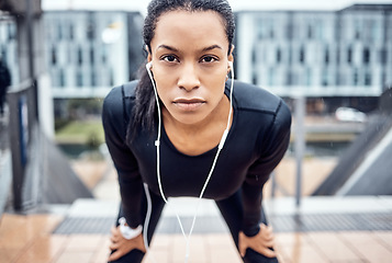 Image showing Portrait, tired and serious with a sports black woman taking a rest from her exercise workout in the city. Face, music and fitness with a young female runner or athlete training alone outside