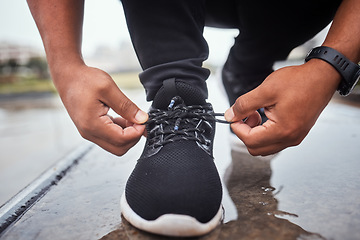 Image showing Exercise, shoes and running with a sports man tying his laces for an outdoor cardio or endurance workout. Fitness, footwear and training with a male athlete or runner fastening his shoelaces outside